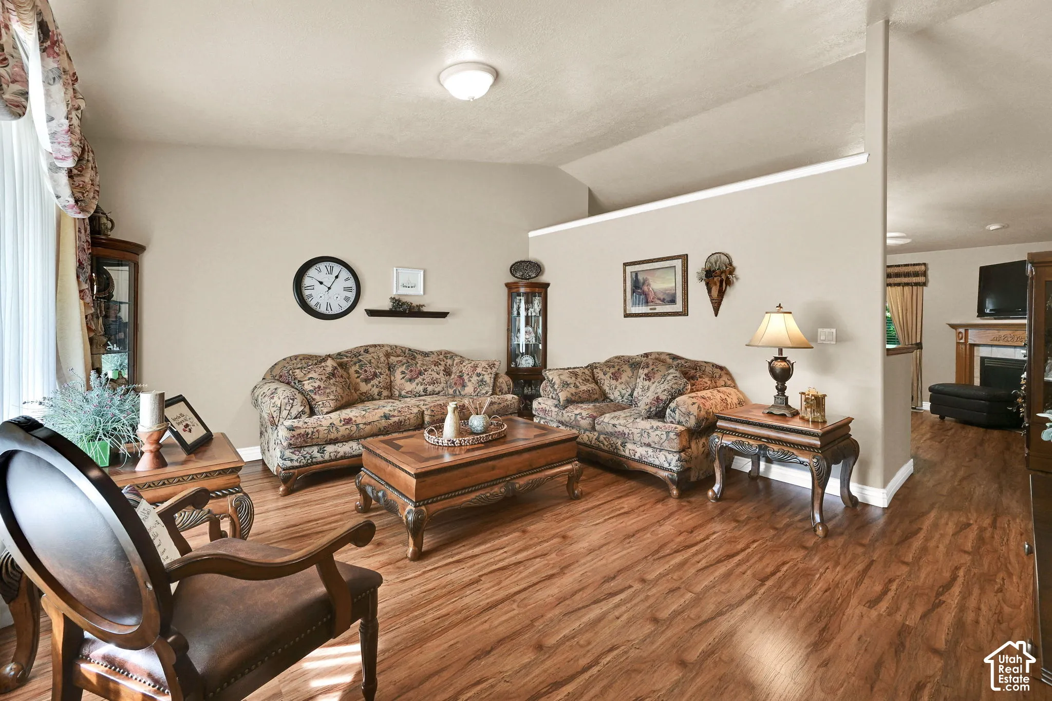 Wood-finish flooring throughout, vaulted ceiling, and recessed ceiling lighting