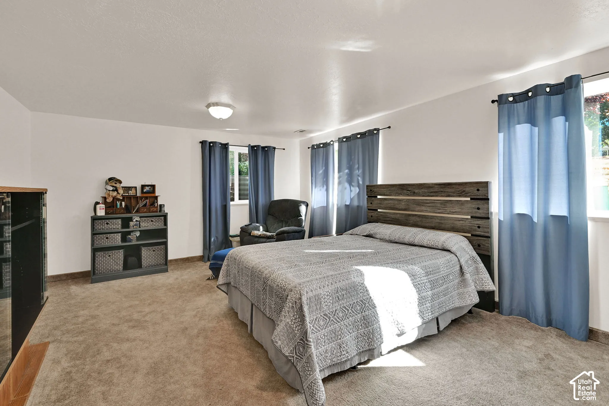 White walls, recessed lighting, and light-colored carpeting