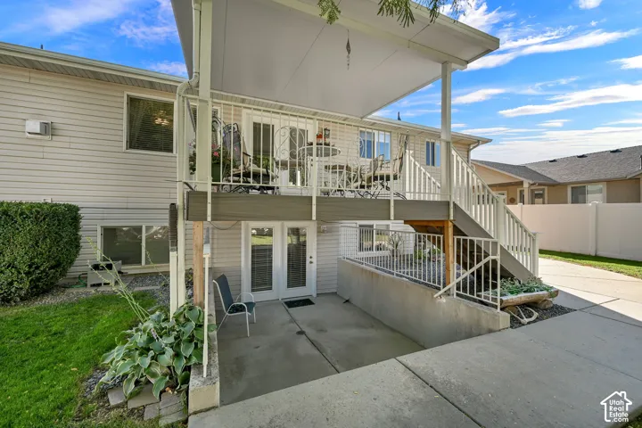 Multi-level outdoor living spaces with a covered upper deck and lower patio