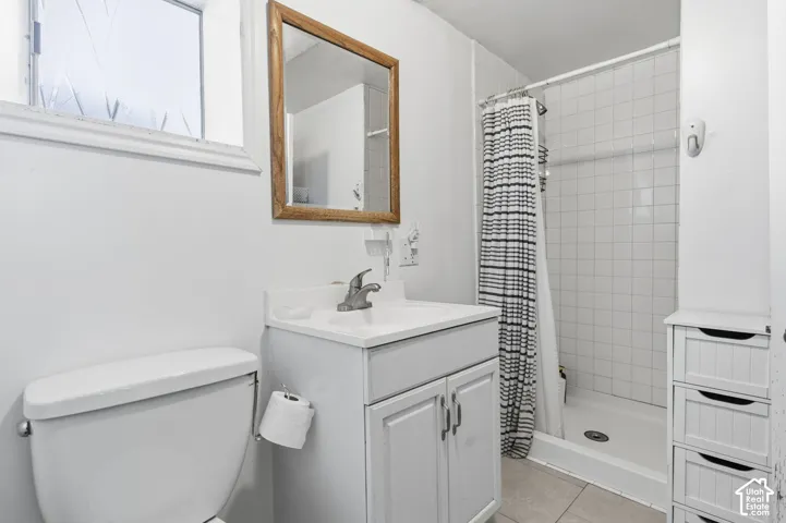 White vanity with integrated sink, chrome faucet, and framed mirror