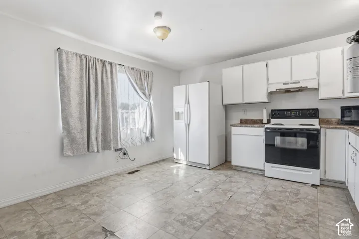 White cabinetry paired with a coordinating white refrigerator