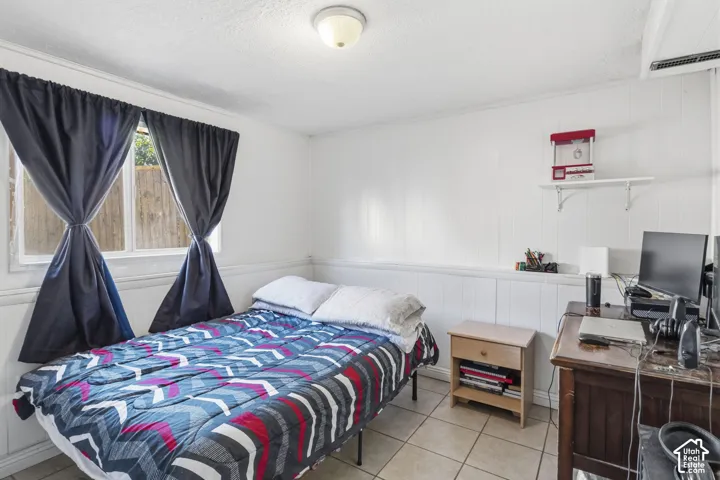 White paneled walls with a chair rail and a window