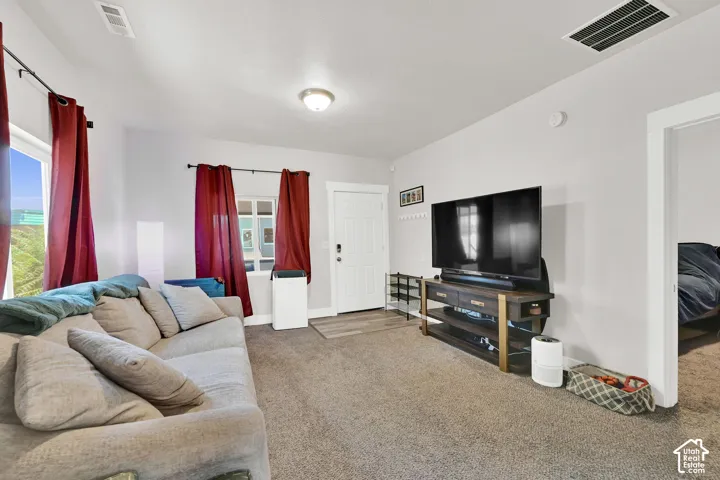 Soft gray carpet throughout, light gray wall paint, and white trim