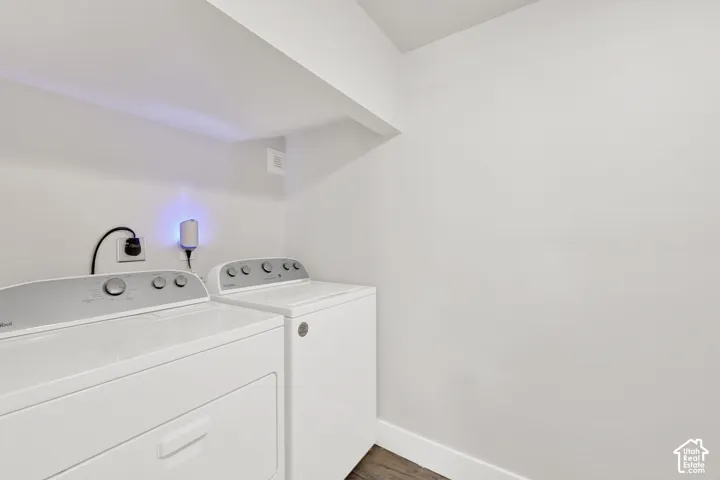 White laundry appliances within a dedicated space