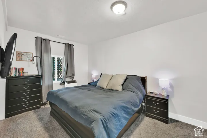 Wall-mounted lighting fixture, window with patterned privacy screen, and neutral wall tones