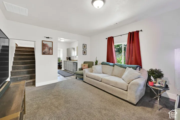 Carpeted living area with a ceiling-mounted light fixture