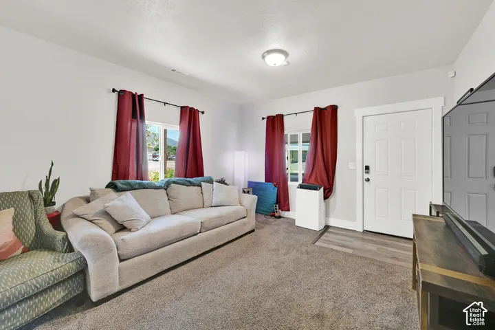 Carpeted flooring, white trim, recessed lighting, and a white paneled entry door