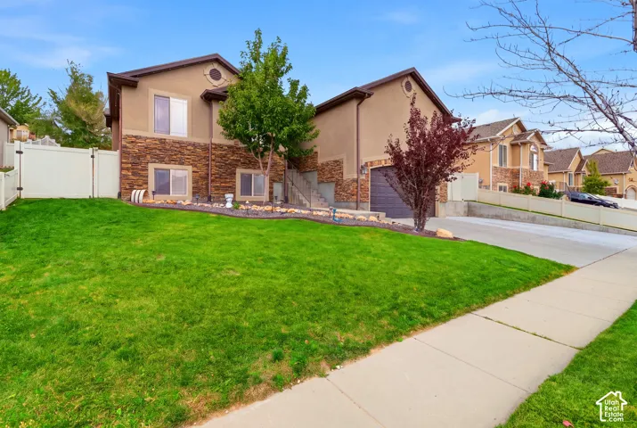 Spacious front lawn with manicured turf and mature landscaping