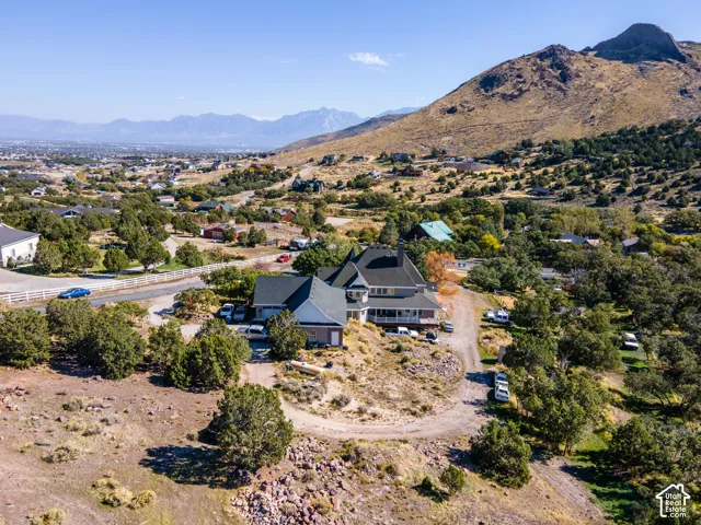 Expansive property with a multi-level residence, attached garage, and multiple outbuildings