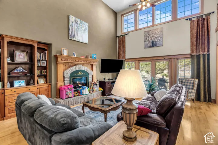 Vaulted ceiling, wood-finish flooring, wood-framed windows, stone and wood fireplace, built-in cabinetry