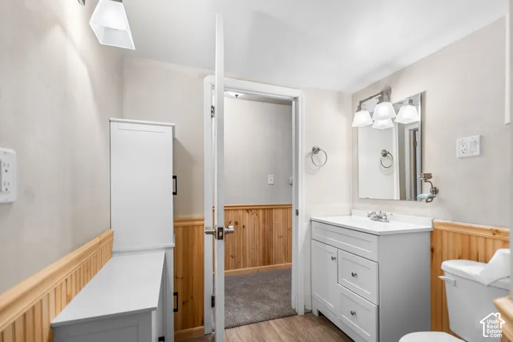 White vanity with built-in storage, white countertop, and integrated sink