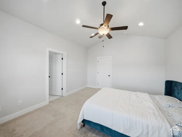 Vaulted ceiling featuring a ceiling fan with integrated lighting
