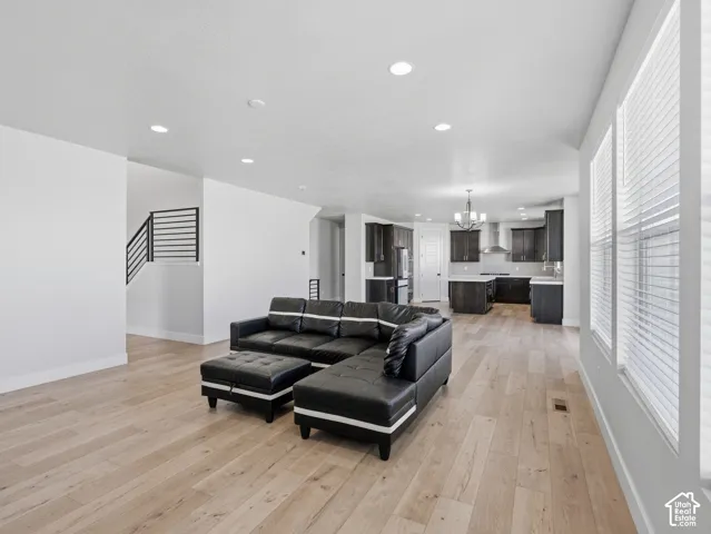 Open-concept living area featuring light wood-finish flooring and recessed lighting
