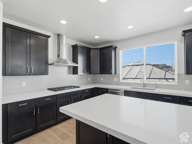 Contemporary kitchen featuring dark wood-finish cabinetry, light countertops, and a white subway tile backsplash