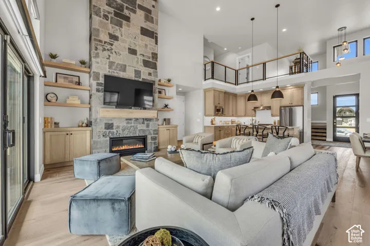 Soaring ceilings with a stone-clad fireplace and built-in shelving
