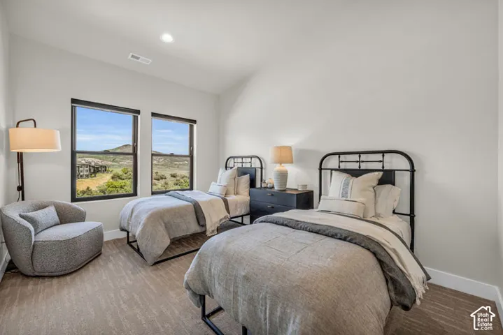 Bright interior space featuring two large windows, recessed lighting, and wood-finish flooring