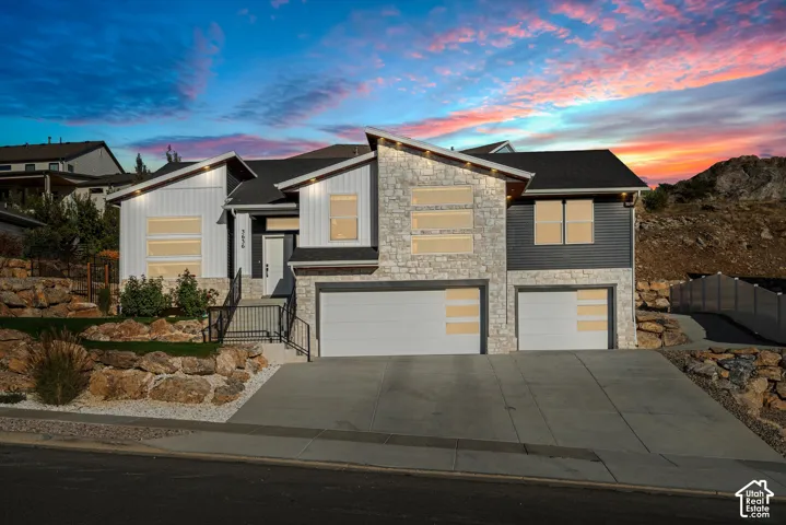 Contemporary exterior featuring stone accents and vertical siding