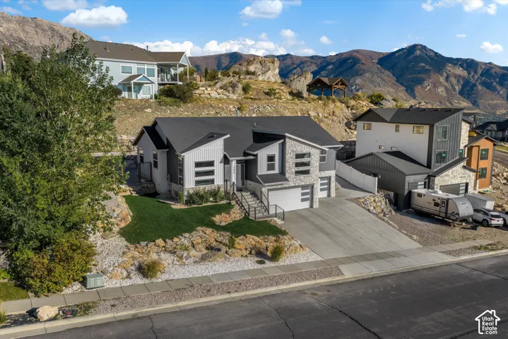 Contemporary home exterior featuring stone and siding finishes