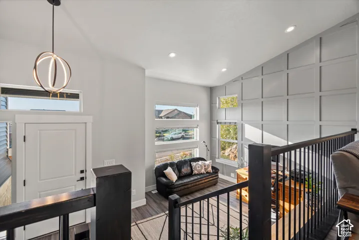 Vaulted ceiling with recessed lighting and a contemporary chandelier
