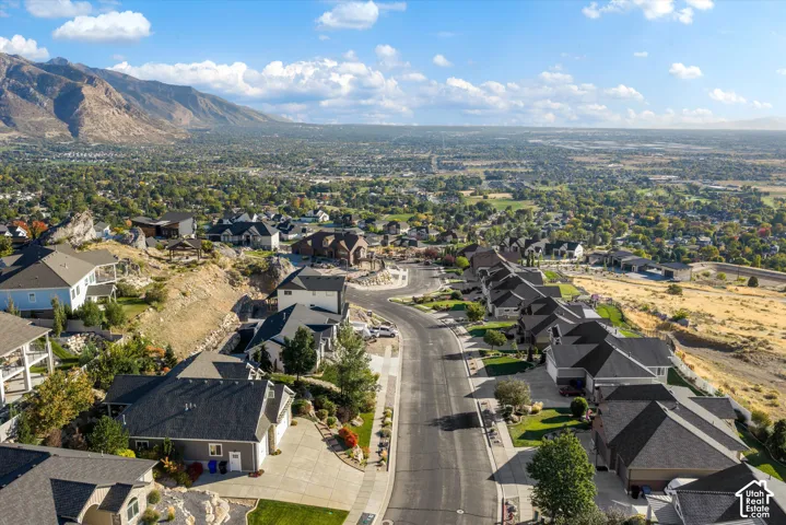 Expansive mountain scenery, suburban neighborhood setting, residential street, and diverse architectural styles