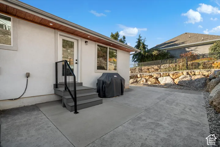 Stamped concrete patio with multi-tiered rock retaining walls