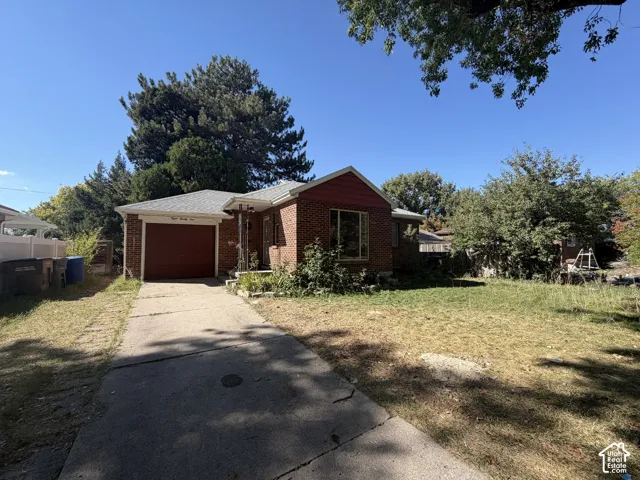 Brick exterior with a single-car garage and concrete driveway