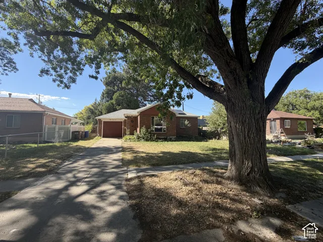 Brick exterior with an attached garage and a concrete driveway