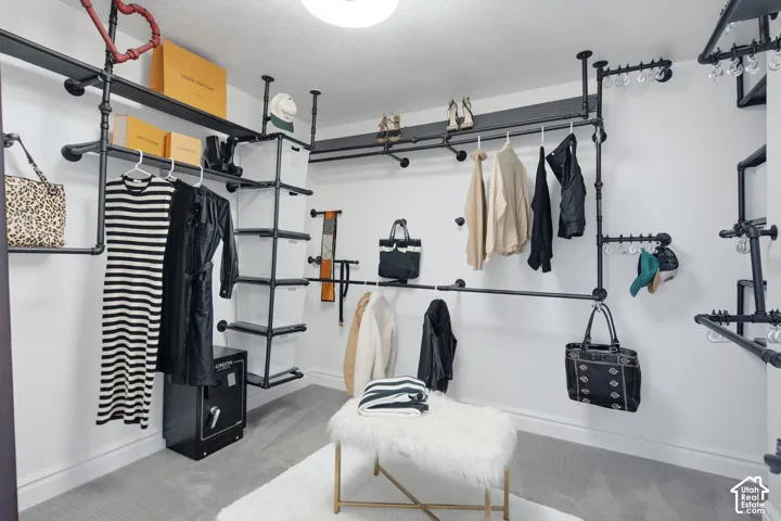 Industrial-style wall-mounted shelving unit featuring matte black pipe framework, integrated hanging rods, and adjustable vertical storage components
