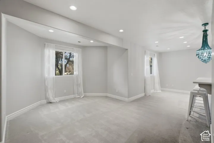 Interior space featuring recessed lighting, a built-in counter surface, and an ornate, multi-tiered crystal chandelier