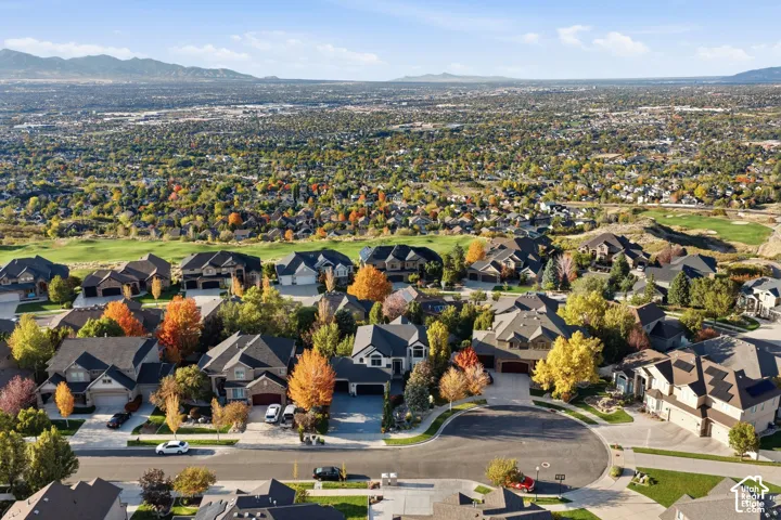 Aerial perspective of the residential property featuring mountainous terrain, expansive regional landscape, and proximity to adjacent open green space