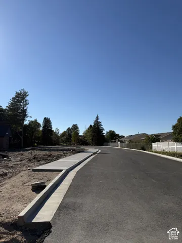 Newly paved street with concrete curb and sidewalk