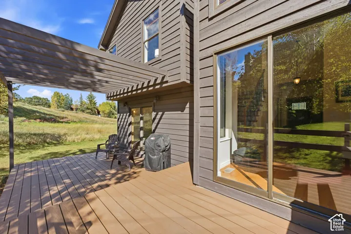 Expansive deck with a pergola, offering outdoor living space