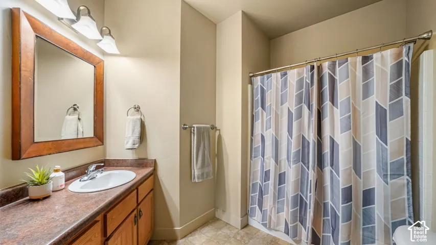 Wood-finish vanity with an integrated sink and countertop