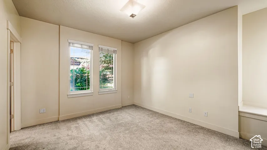 Recessed window shelf, neutral tone carpeting, and dual windows