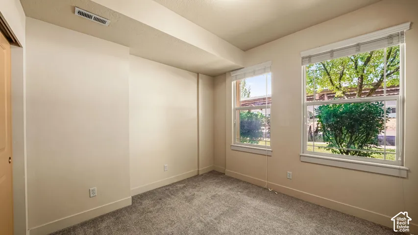 Light-colored walls with textured carpet flooring