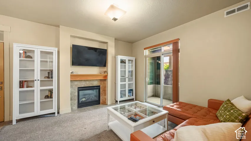 Built-in fireplace with stone tile surround and wood mantel
