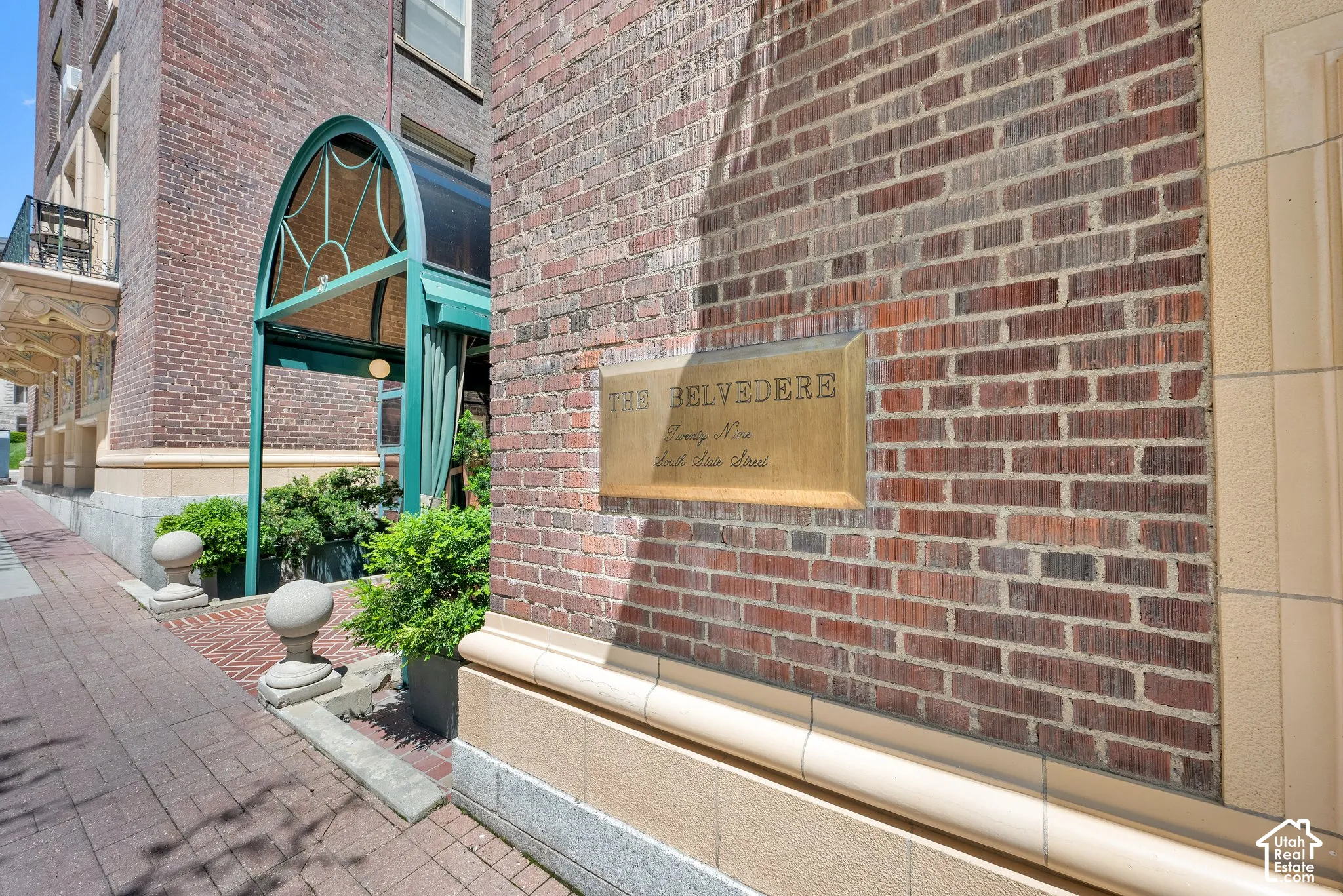Brick exterior with light-colored trim and a brass nameplate