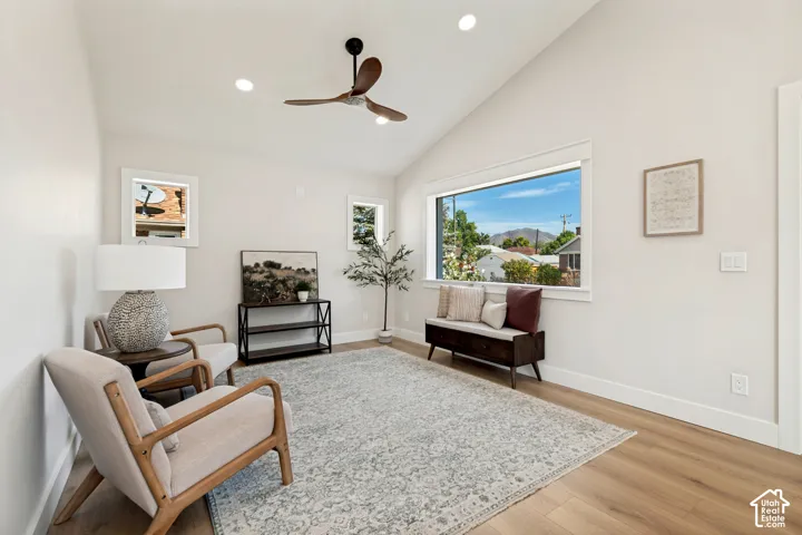 Vaulted ceiling with recessed lighting and a ceiling fan