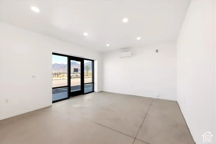 Polished concrete flooring, recessed lighting, and a wall-mounted mini-split system