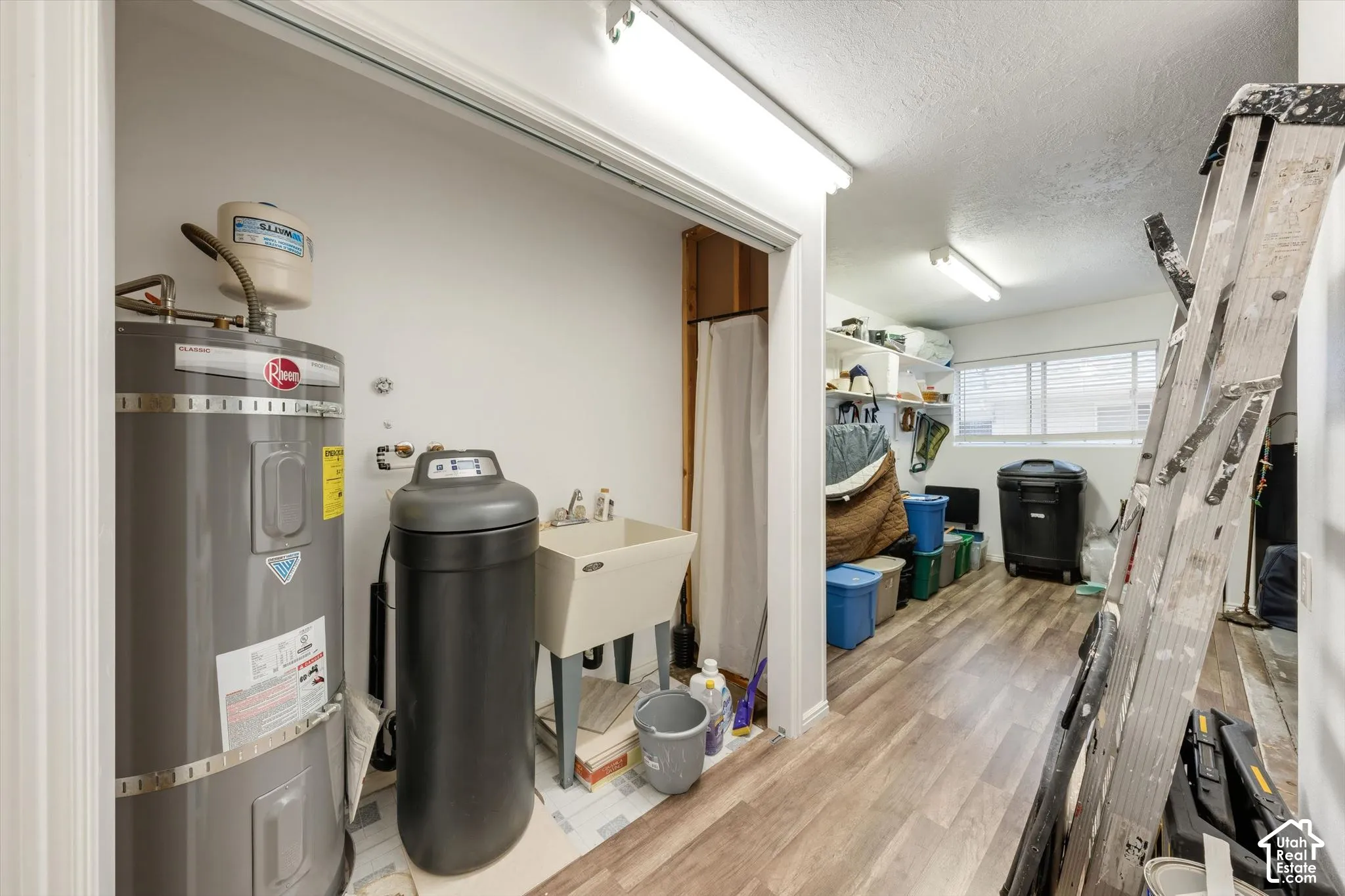Water heater, utility sink, water softener, wood-finish flooring, built-in shelving