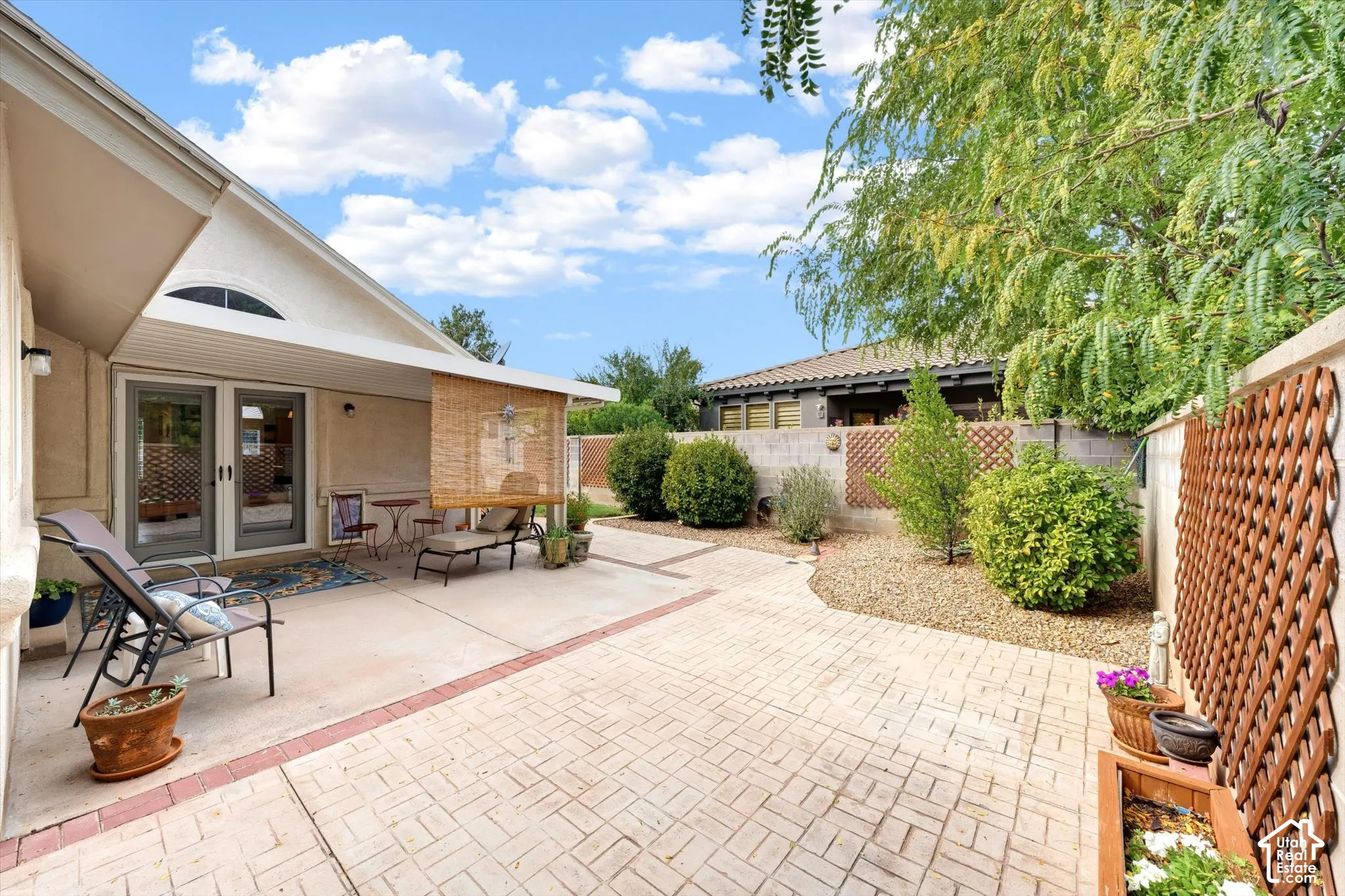 Expansive patio with stamped concrete, offering multiple outdoor living zones