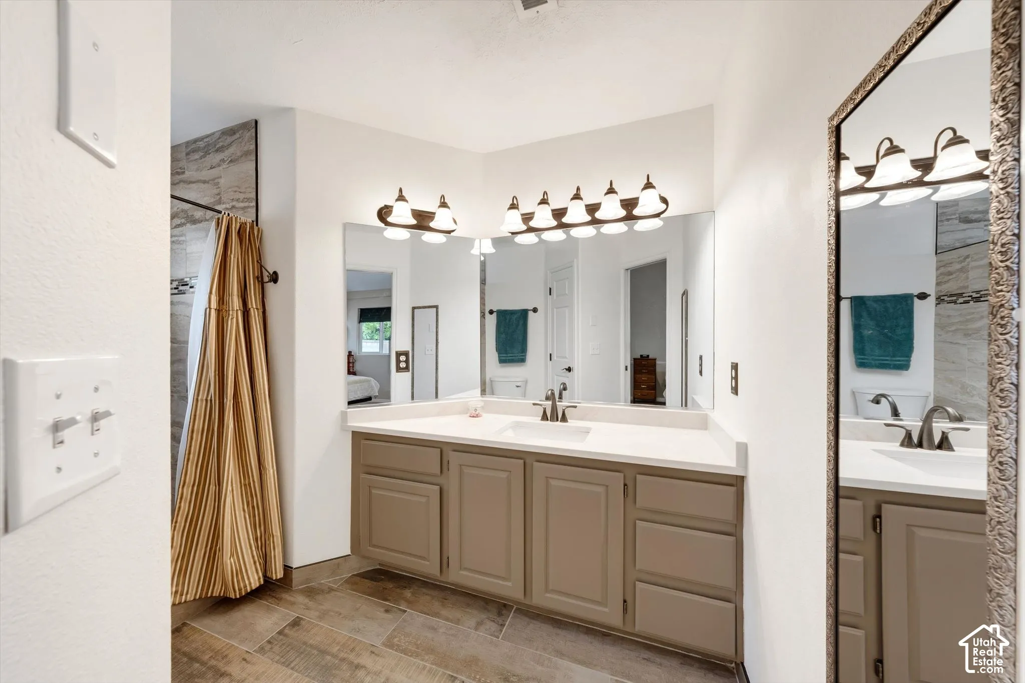 Double vanity with integrated sinks, brushed nickel faucets, and under-cabinet storage
