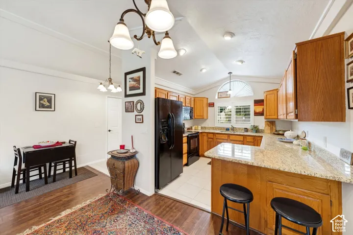 Kitchen featuring wood-finish cabinetry, light-toned countertops, and recessed lighting