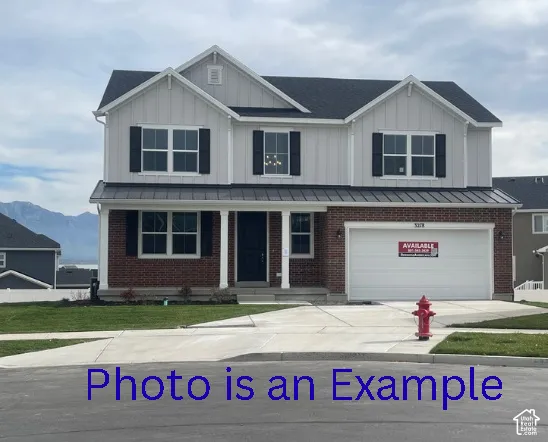 Two-story property featuring brick and board-and-batten siding