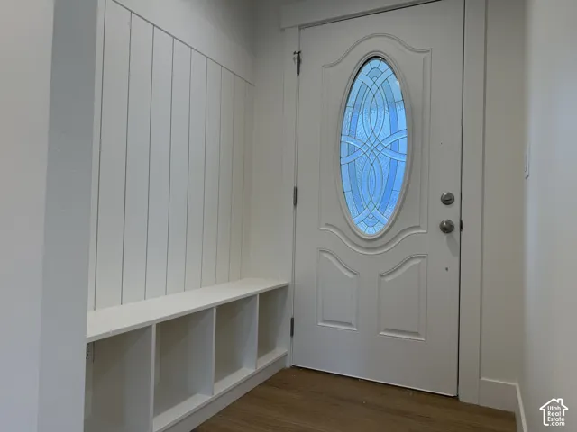 Entryway featuring built-in bench seating with cubbies and board-and-batten wall detailing