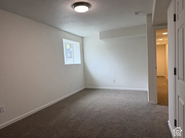Wall-to-wall carpeting, recessed window, flush-mount ceiling light fixture, white interior walls, and white trim