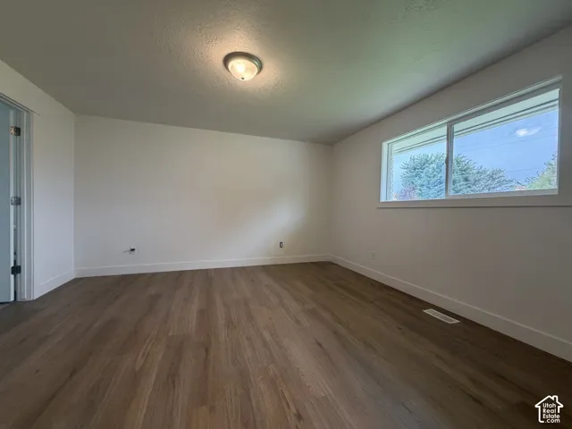 Wood-finish flooring, white walls, and a contemporary window with ample natural light