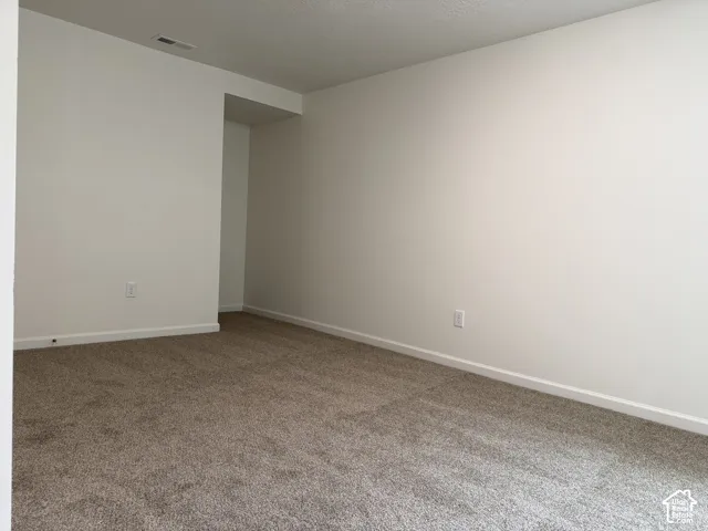 Wall-to-wall carpet flooring, neutral paint palette, and white trim