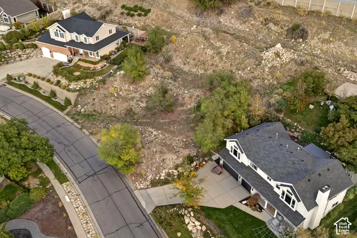 Two-story residence with a multi-car garage, pitched roof, and a paved driveway