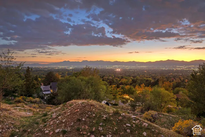 Expansive elevated terrain overlooking a distant city and mountain range